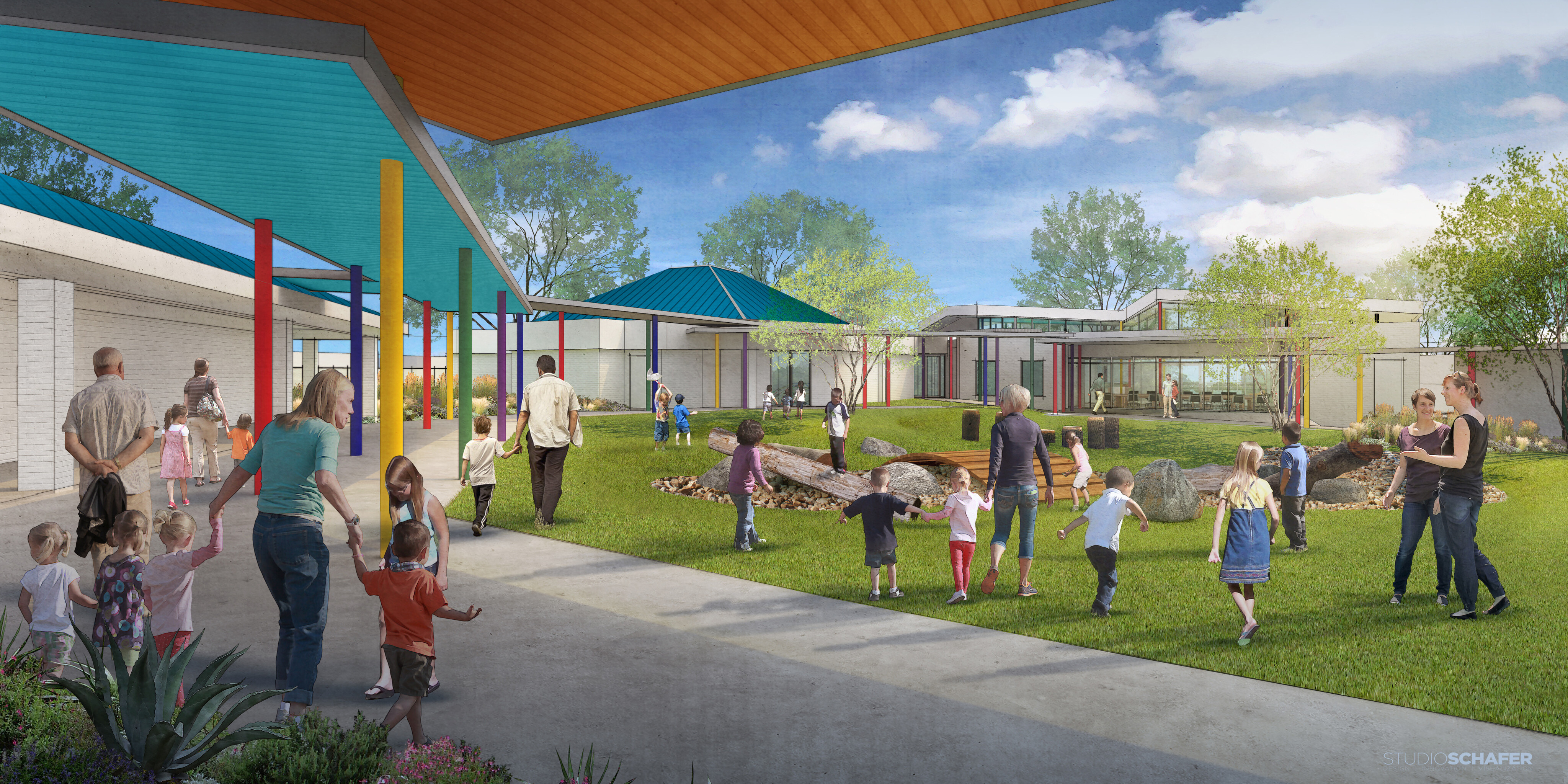 A courtyard at Brighton Center with children playing and people walking, surrounded by buildings with bright blue and yellow roofs, under a clear blue sky with scattered clouds.